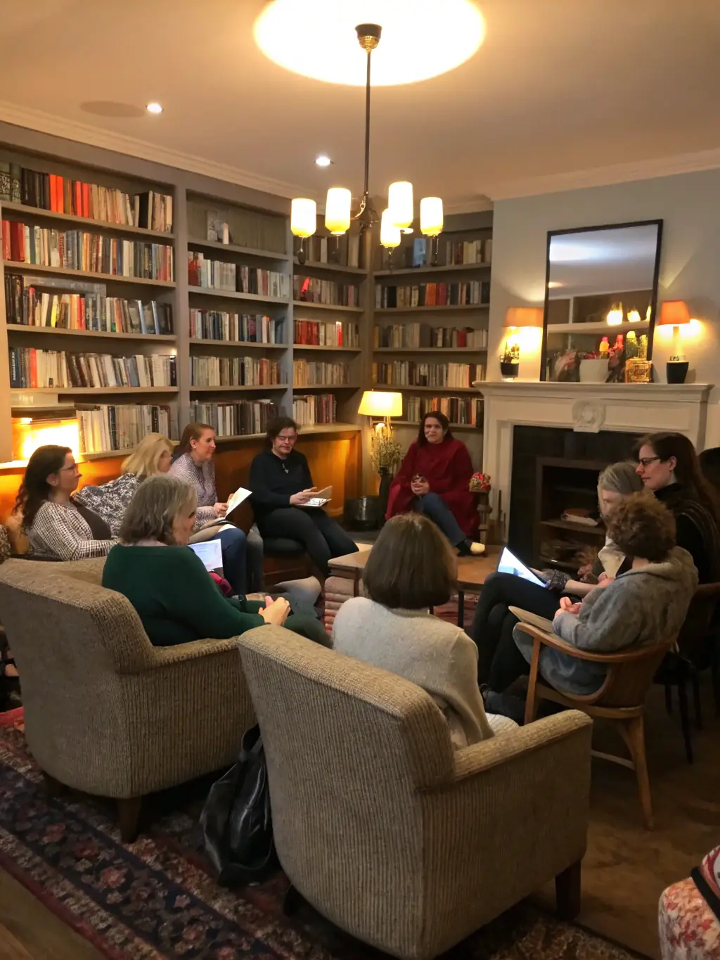 A photograph of community members participating in a book club discussion at the library, with books and refreshments on the table. The image should convey a sense of camaraderie and intellectual exchange.